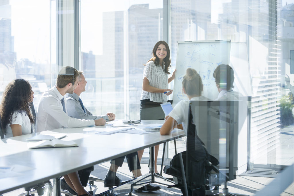 Woman giving a presentation to her team.
